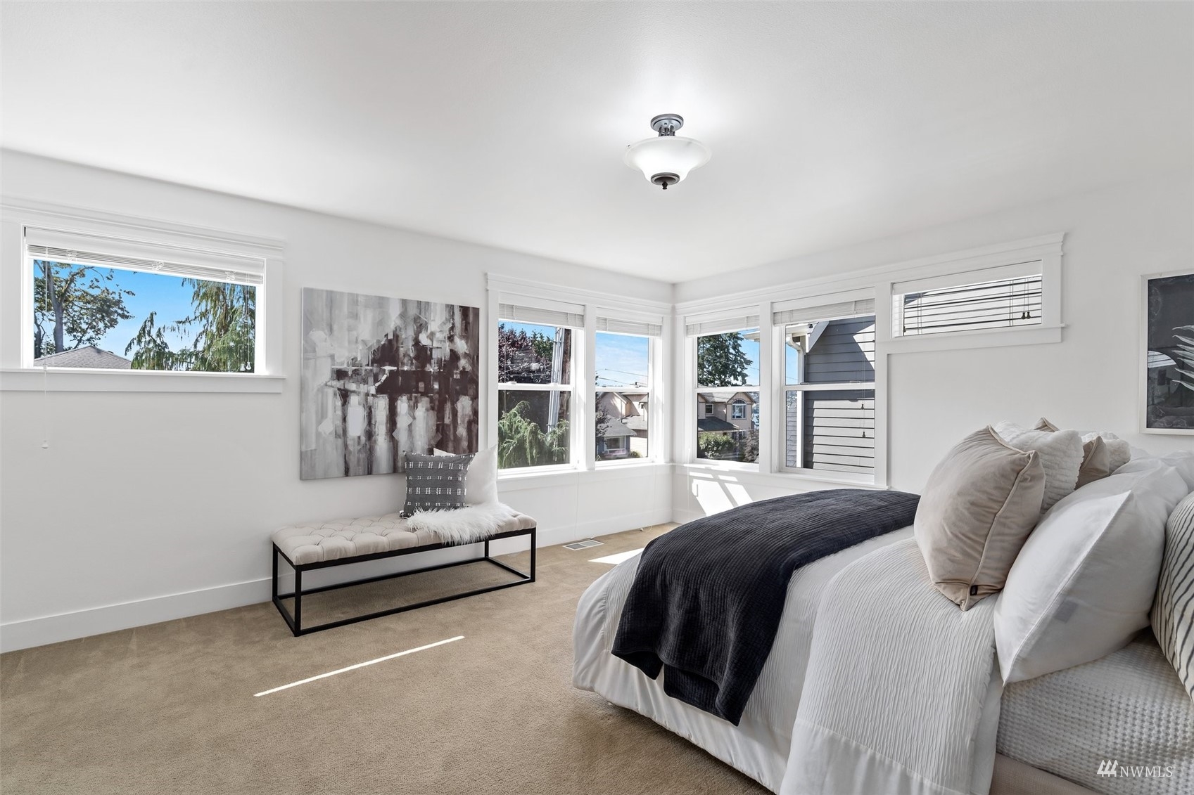 1012 North 29th Street Renton, WA 98056 - Photo 20 of 40 a spacious bedroom with a bed a couch and large window