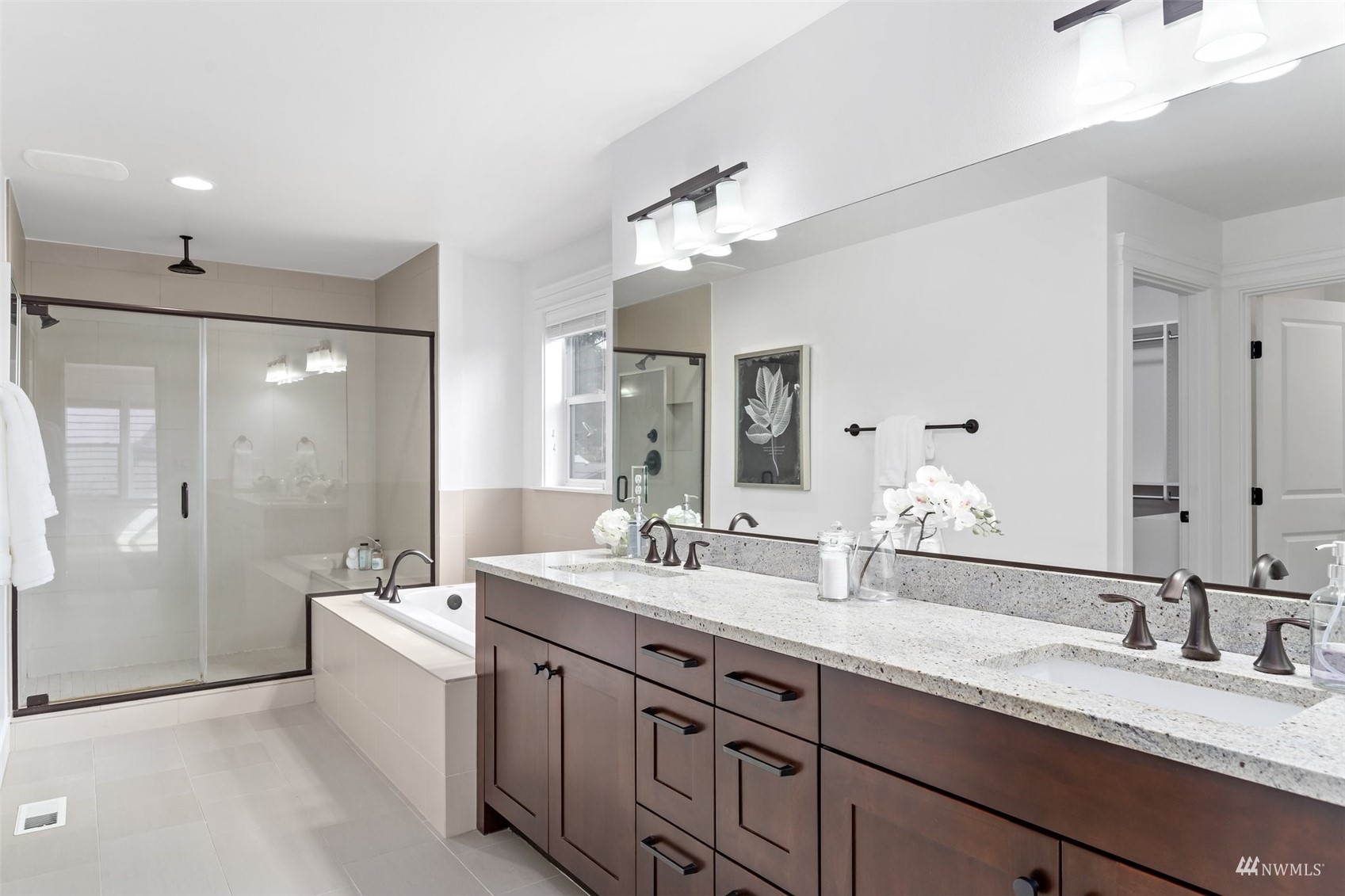 1012 North 29th Street Renton, WA 98056 - Photo 24 of 40 a bathroom with a double vanity sink a mirror and a shower