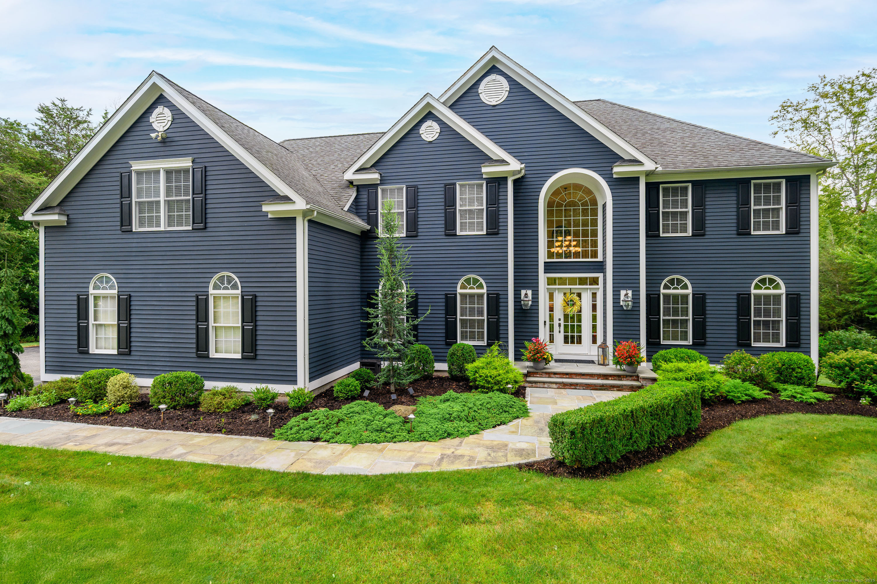 a front view of a house with a yard