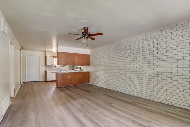 a view of kitchen with stainless steel appliances wooden floor