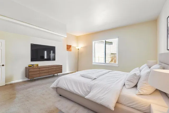 a bathroom with a sink a toilet a mirror and shower