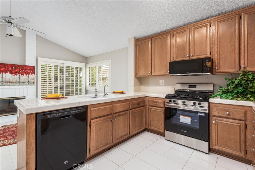 680 Indian Wells Road Banning, CA 92220 - Photo 11 of 37 a kitchen with stainless steel appliances granite countertop a stove sink and cabinets