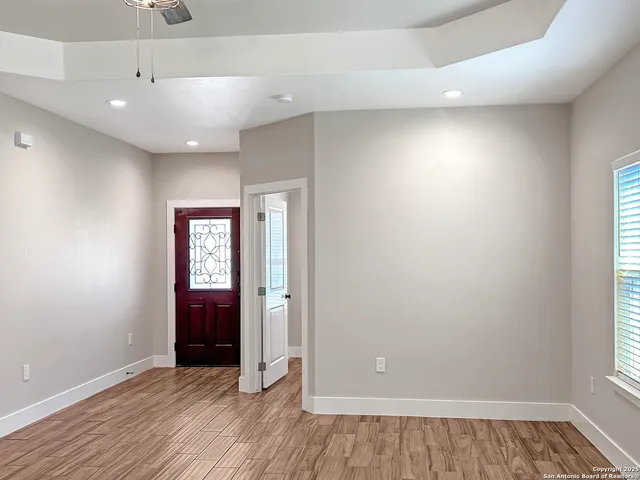 wooden floor in an empty room with a window