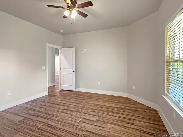 wooden floor in an empty room with a window
