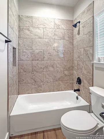 a bathroom with a bathtub and a toilet