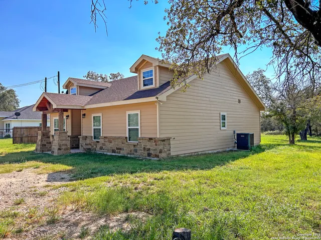 a view of a house with a yard and sitting area
