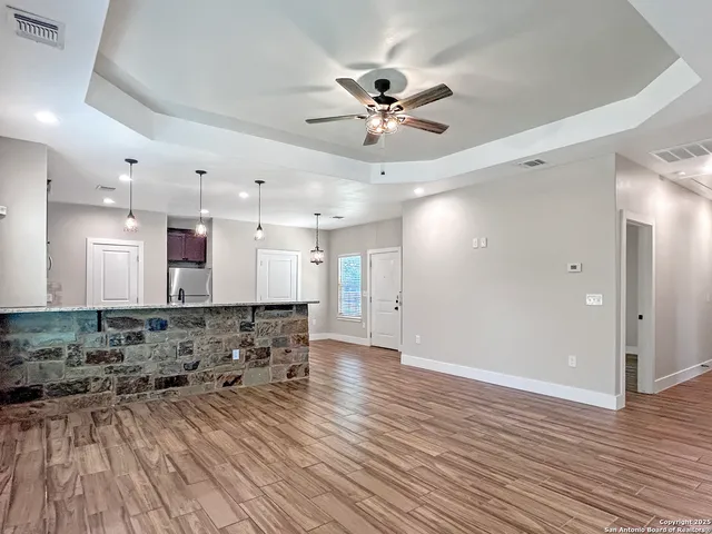 a view of a room with wooden floor and staircase