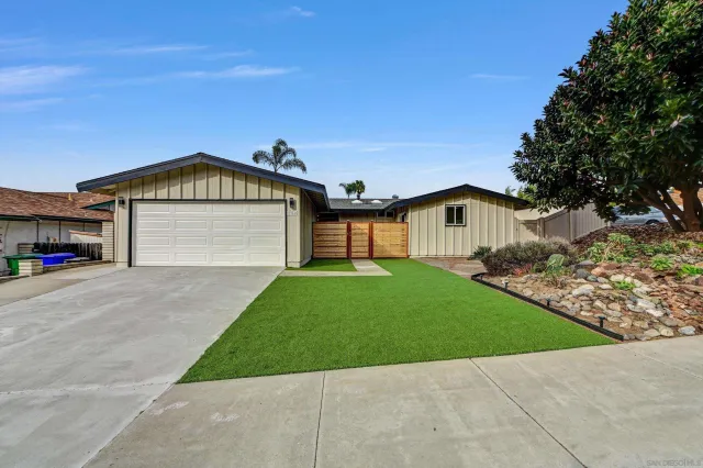 a front view of a house with a garden and deck