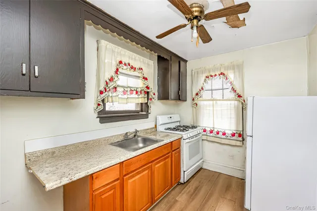 a kitchen with stainless steel appliances granite countertop a sink and cabinets