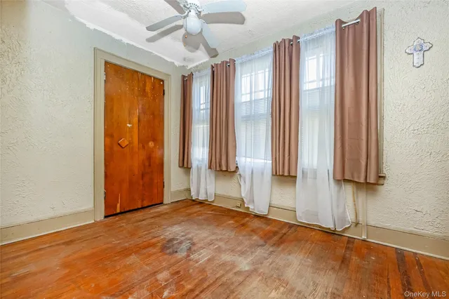 an empty room with a window and a bathroom