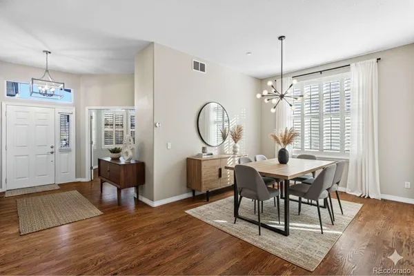 a view of a dining room with furniture window and wooden floor
