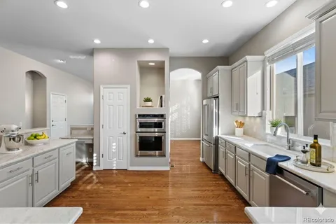 a large kitchen with a large counter top appliances and cabinets