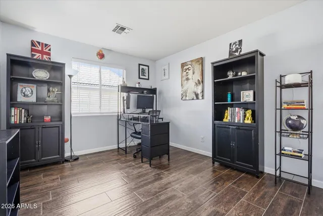 a view of a workspace with furniture and wooden floor