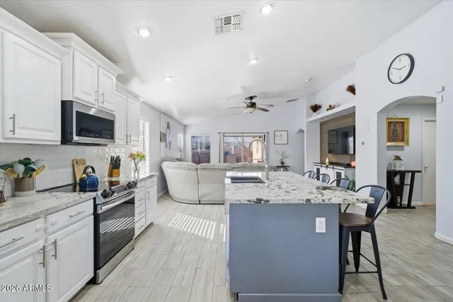 a kitchen with sink a microwave and refrigerator