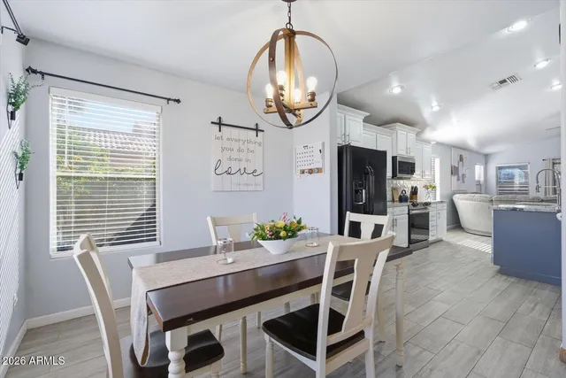 a view of a kitchen island a sink wooden floor and a living room