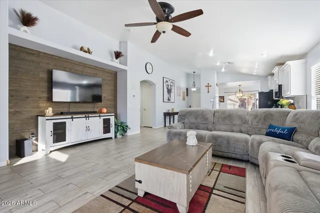 a living room with furniture and wooden floor