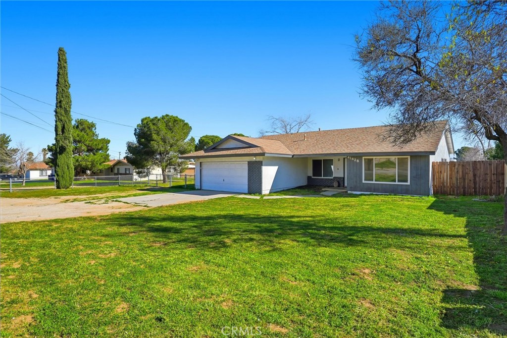 41428 50th Street West Lancaster, CA 93536 - Photo 1 of 46 a front view of a house with garden