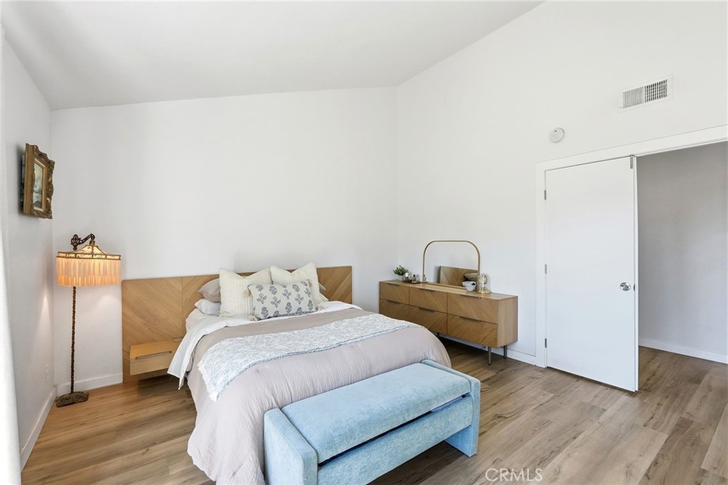 41428 50th Street West Lancaster, CA 93536 - Photo 19 of 46 a bedroom with a bed and wooden floor