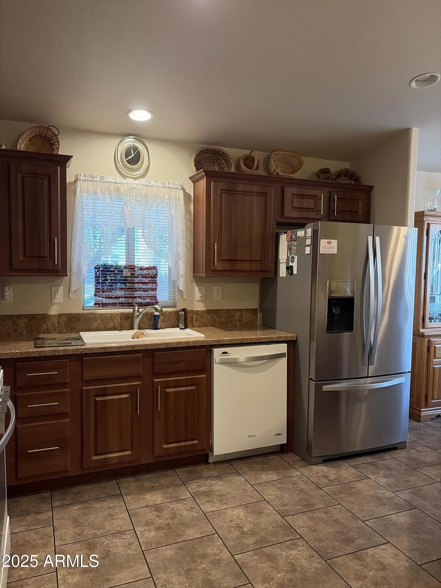 2929 East Main Street, Unit 43 Mesa, AZ 85213 - Photo 14 of 36 a kitchen with stainless steel appliances granite countertop a refrigerator and a sink