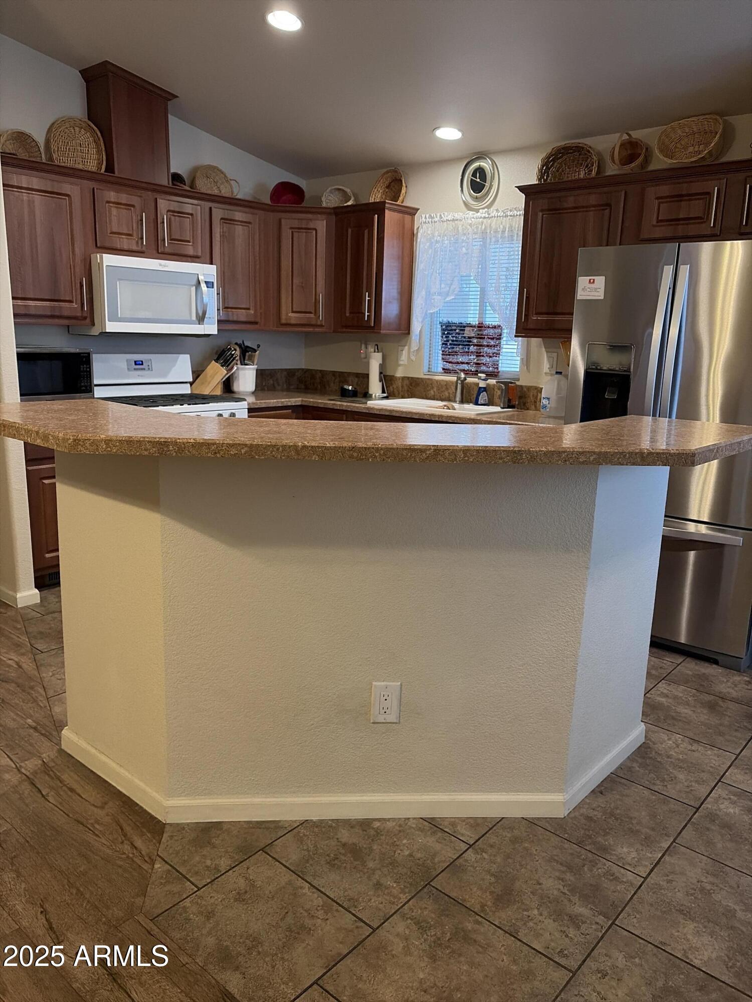 2929 East Main Street, Unit 43 Mesa, AZ 85213 - Photo 20 of 36 a kitchen with stainless steel appliances a refrigerator a sink a stove a microwave and cabinets