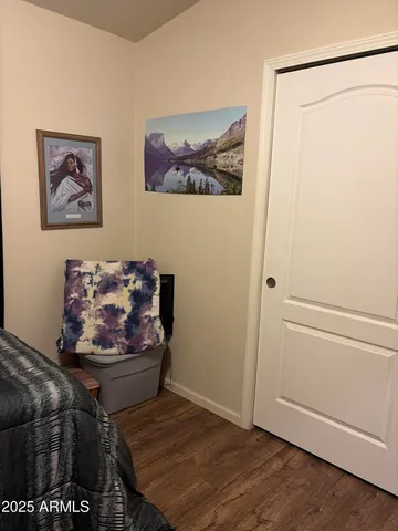 a living room with furniture and paintings on the wall