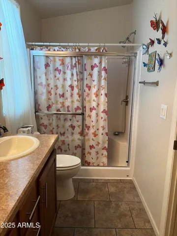 a view of a hallway to a livingroom with wooden floor
