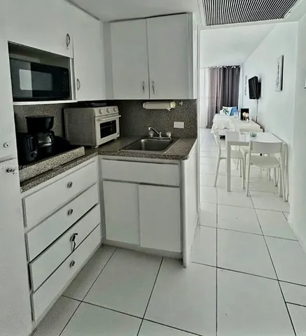 a kitchen with stainless steel appliances a stove a sink and a microwave