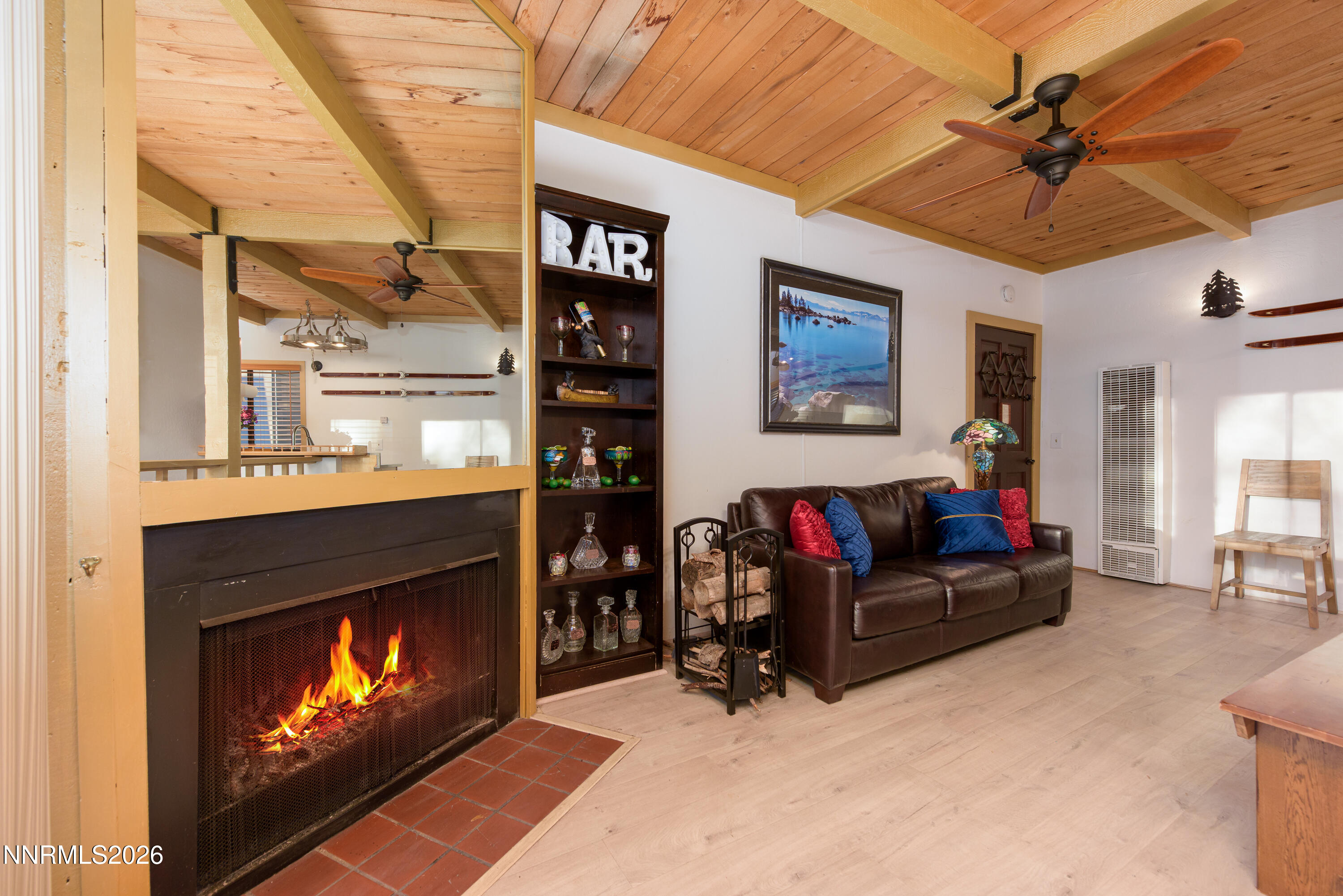a living room with furniture a fireplace and a ceiling fan