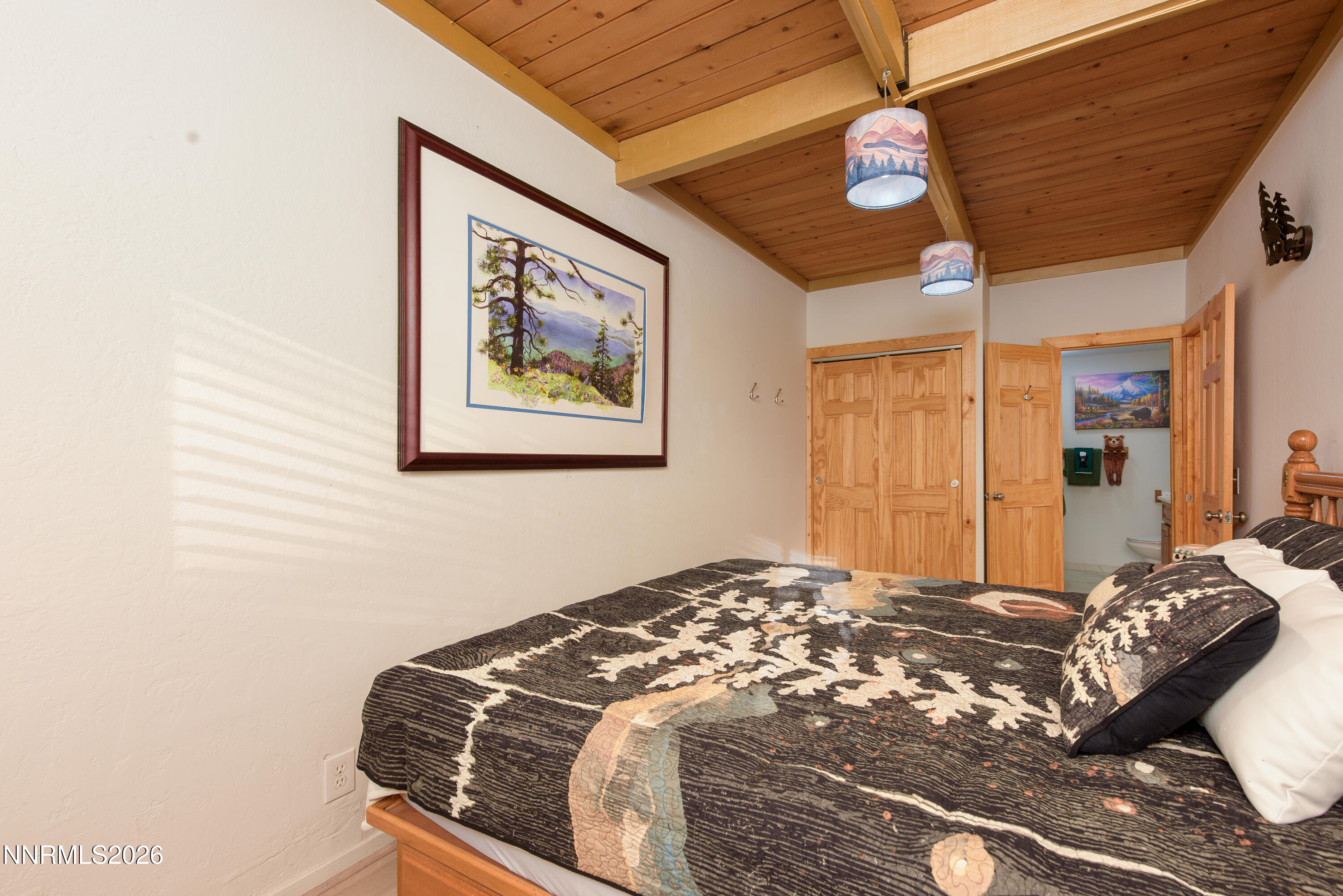 111 Tramway Drive, Unit 5 Stateline, NV 89449 - Photo 13 of 24 a bedroom with a large bed and a chandelier