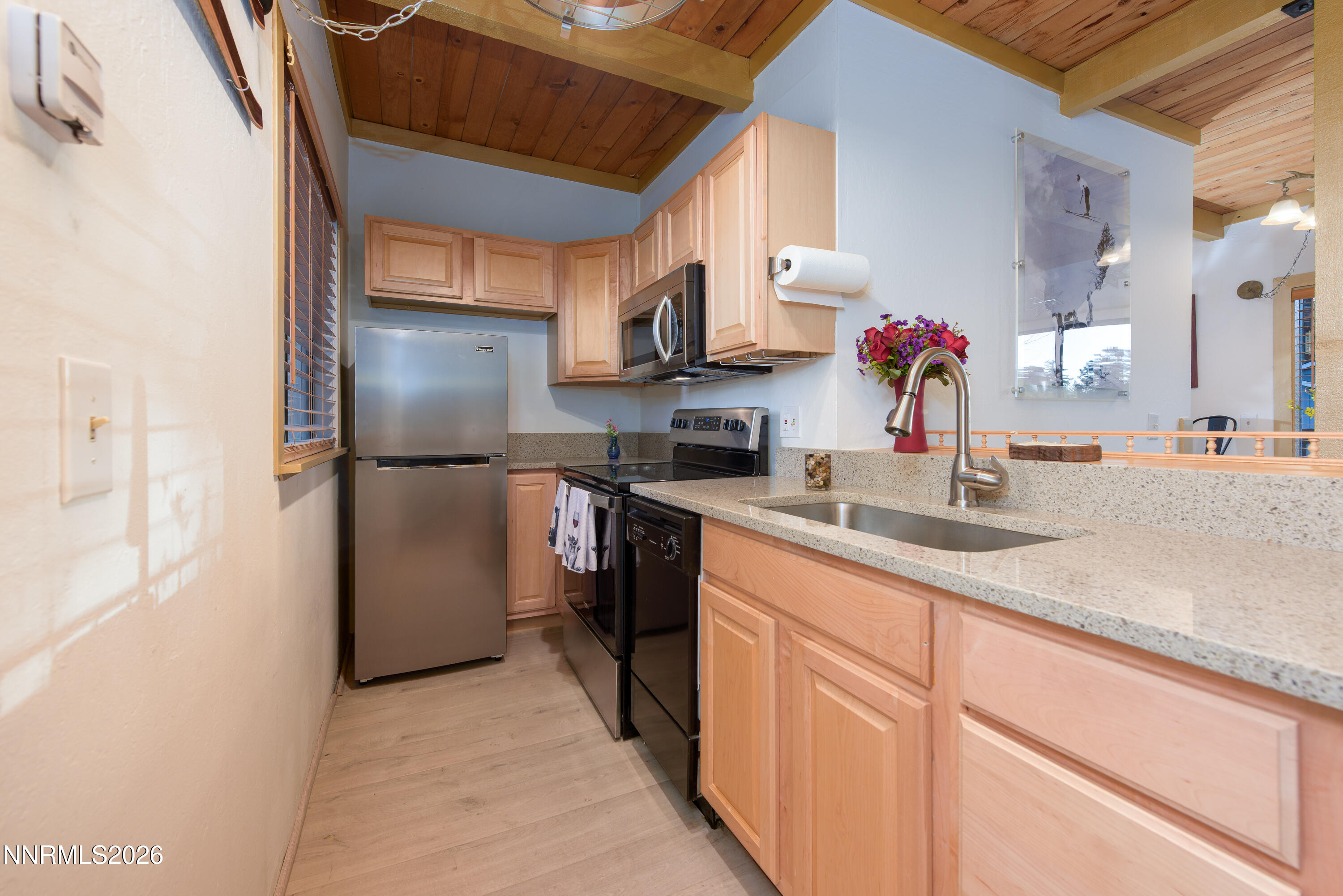 111 Tramway Drive, Unit 5 Stateline, NV 89449 - Photo 3 of 24 a kitchen with granite countertop a sink stainless steel appliances and cabinets