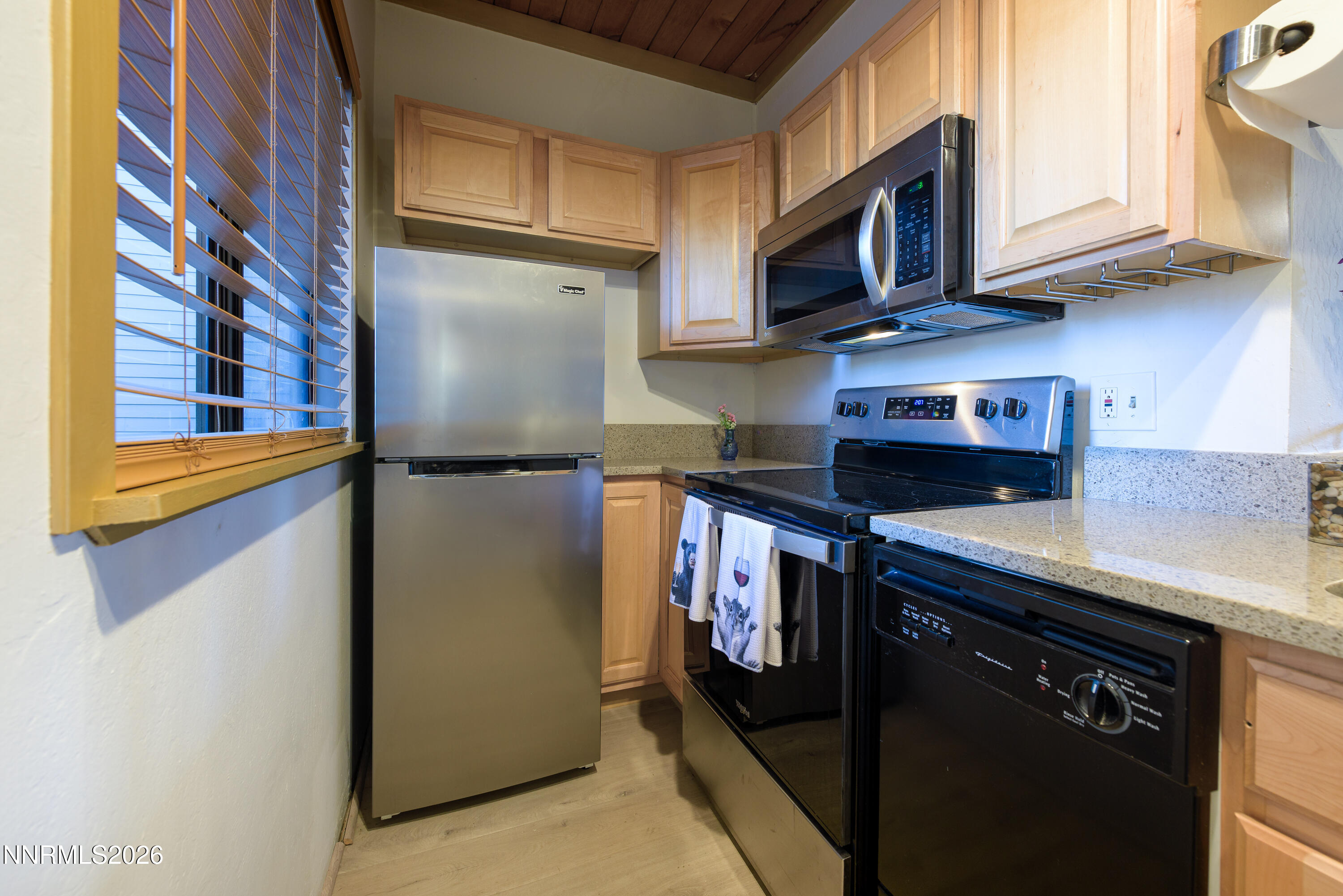 111 Tramway Drive, Unit 5 Stateline, NV 89449 - Photo 9 of 24 a kitchen with stainless steel appliances granite countertop a refrigerator a stove and a sink