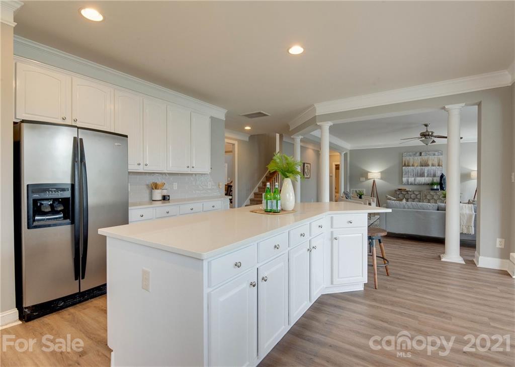 2314 Mermans Road Charlotte, NC 28270 - Photo 11 of 45 a kitchen with white cabinets and stainless steel appliances