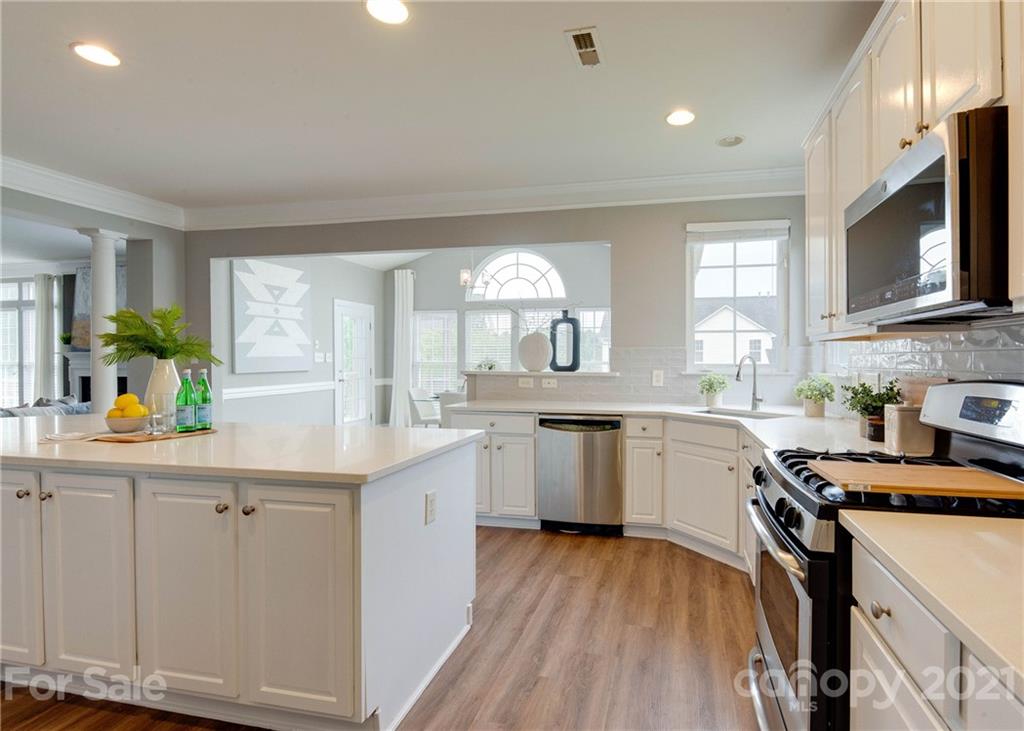 2314 Mermans Road Charlotte, NC 28270 - Photo 12 of 45 a kitchen with granite countertop a sink a counter space appliances and cabinets