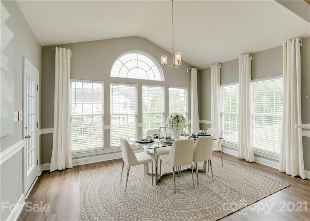 2314 Mermans Road Charlotte, NC 28270 - Photo 15 of 45 a dining room with furniture a chandelier and wooden floor