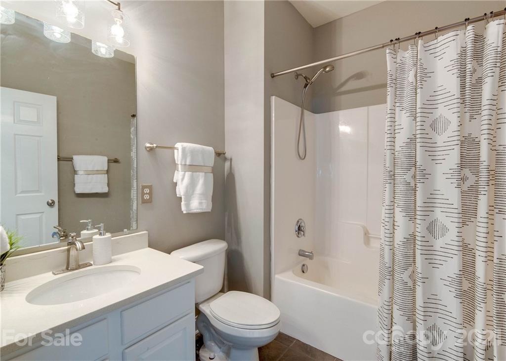 2314 Mermans Road Charlotte, NC 28270 - Photo 17 of 45 a bathroom with a sink a toilet and shower