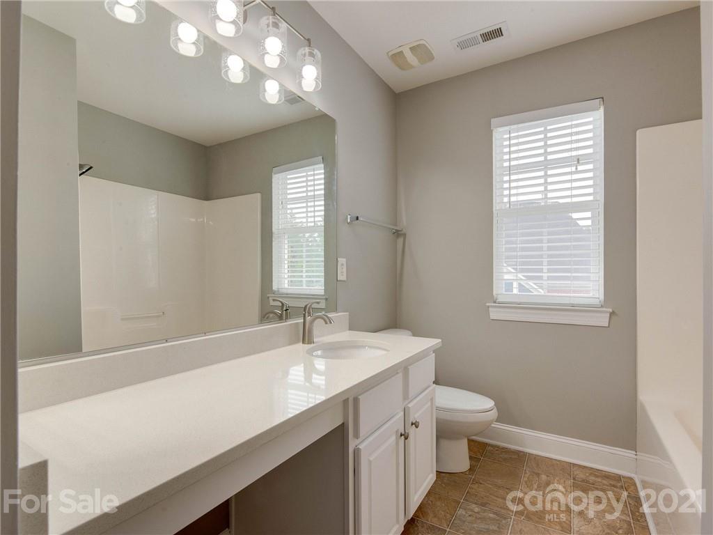 2314 Mermans Road Charlotte, NC 28270 - Photo 19 of 45 a bathroom with a sink a toilet and a mirror