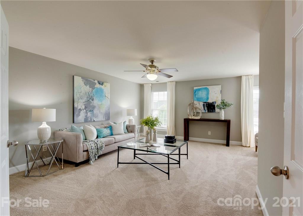 2314 Mermans Road Charlotte, NC 28270 - Photo 23 of 45 a living room with furniture and a chandelier