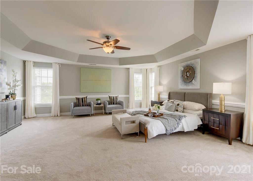 2314 Mermans Road Charlotte, NC 28270 - Photo 27 of 45 a spacious bedroom with a bed and a chandelier