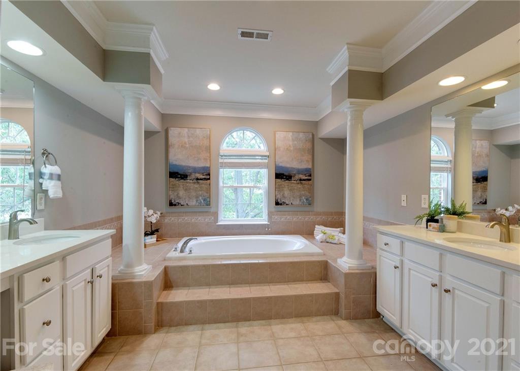 2314 Mermans Road Charlotte, NC 28270 - Photo 29 of 45 a spacious bathroom with a tub sink and mirror
