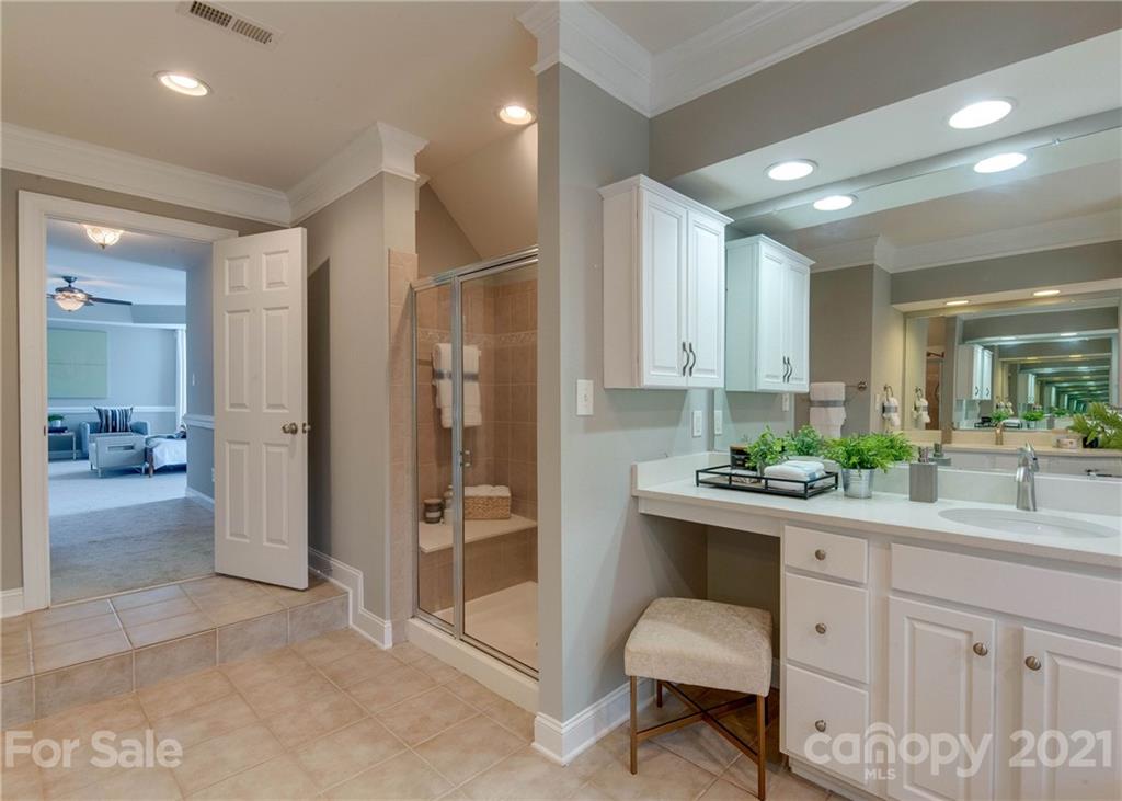 2314 Mermans Road Charlotte, NC 28270 - Photo 30 of 45 a hallway with a sink and a large mirror