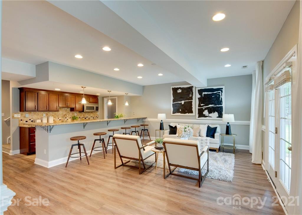 2314 Mermans Road Charlotte, NC 28270 - Photo 32 of 45 a living room with furniture a flat screen tv and kitchen view