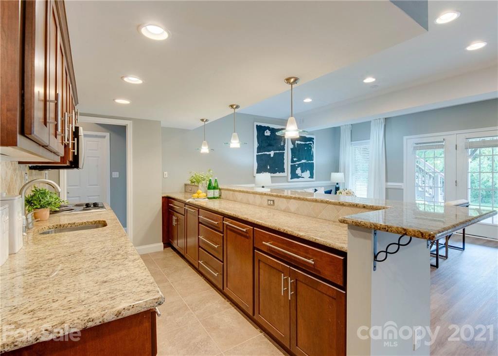 2314 Mermans Road Charlotte, NC 28270 - Photo 35 of 45 a large kitchen with stainless steel appliances kitchen island granite countertop a sink and cabinets