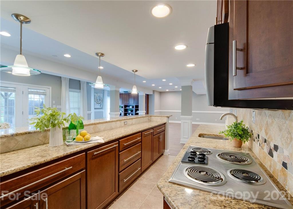 2314 Mermans Road Charlotte, NC 28270 - Photo 36 of 45 a kitchen with sink stove and cabinets