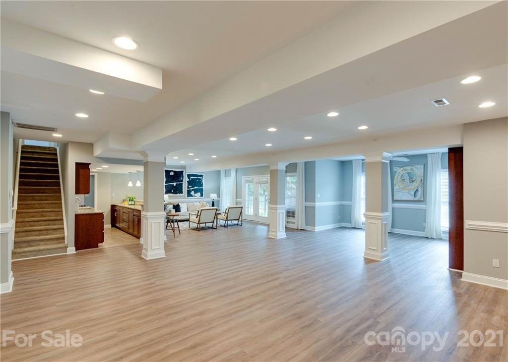 2314 Mermans Road Charlotte, NC 28270 - Photo 37 of 45 an open kitchen with kitchen island wooden floors and living room view