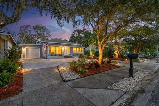 a view of a house with backyard and sitting area