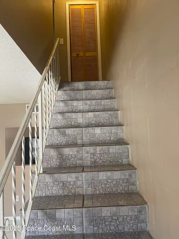 a view of staircase with white walls and windows