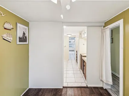 an entryway to room with wooden floor