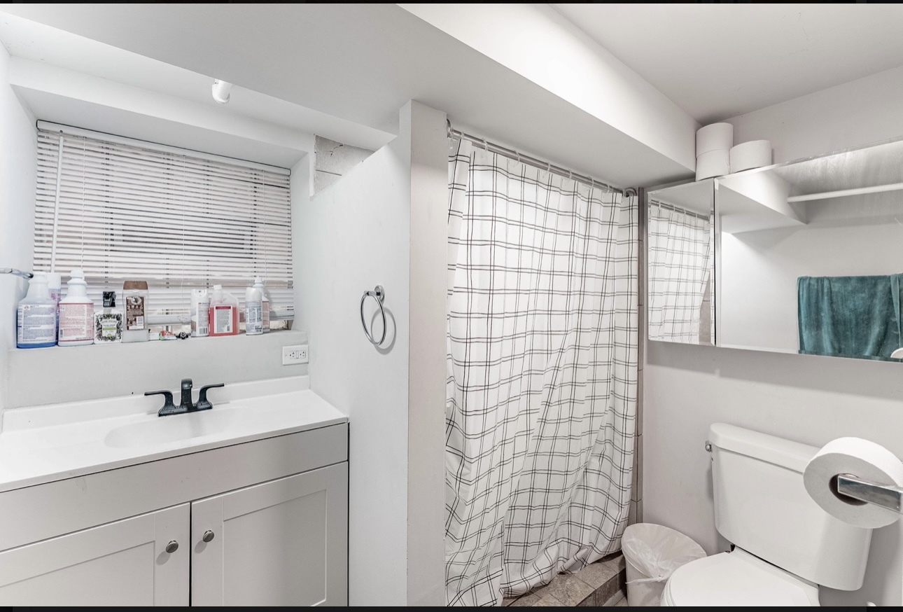 6241 South Troy Street, Unit B Chicago, IL 60629 - Photo 8 of 9 a bathroom with a sink mirror vanity and toilet