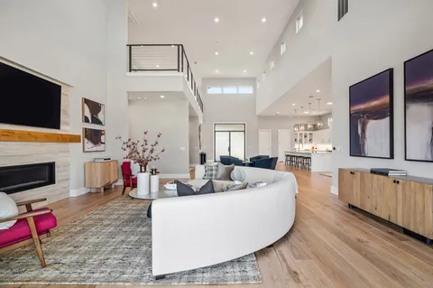 a living room with fireplace furniture and a flat screen tv