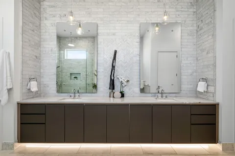 a bathroom with a double vanity sink and a mirror